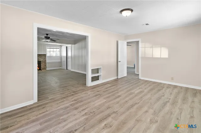 wooden floor in an empty room with a window