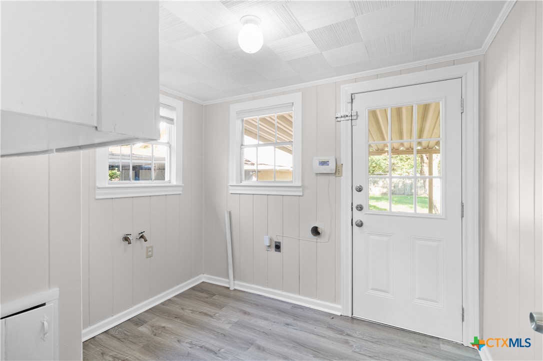 606 West Gayle Street Edna, TX 77957 - Photo 10 of 20 a view of an empty room with wooden floor and a window