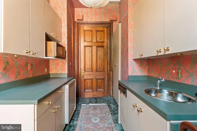 a kitchen with a sink and a refrigerator