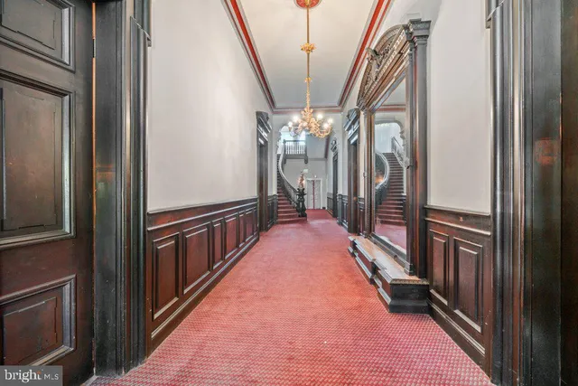 a view of a hallway with a chandelier