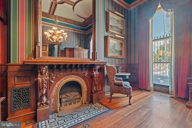 a living room with a fireplace a rug and windows