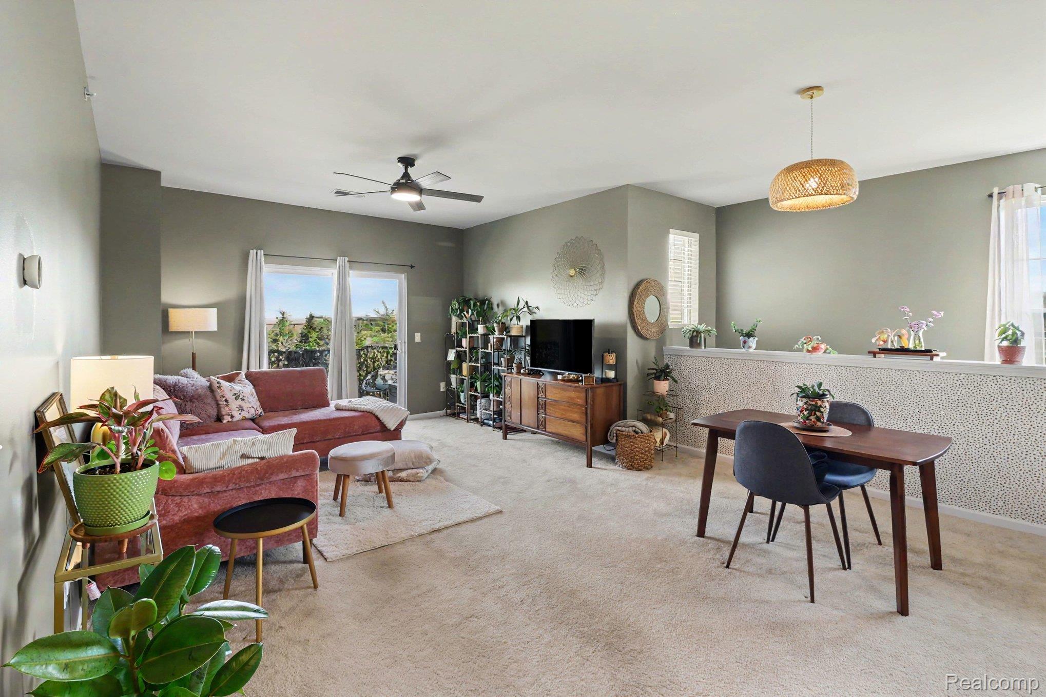 9864 Ridge Run Street Howell, MI 48855 - Photo 9 of 23 Living area featuring ceiling fan and light carpet