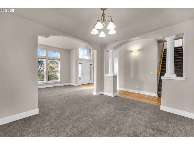 a view of an empty room with a chandelier