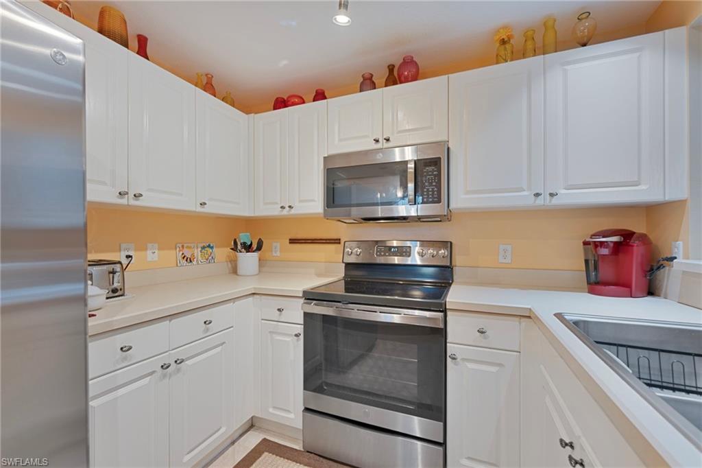 6765 Huntington Lakes Circle, Unit 102 Naples, FL 34119 - Photo 6 of 22 Pleasant Cabinets and Countertop, Includes a Pantry
