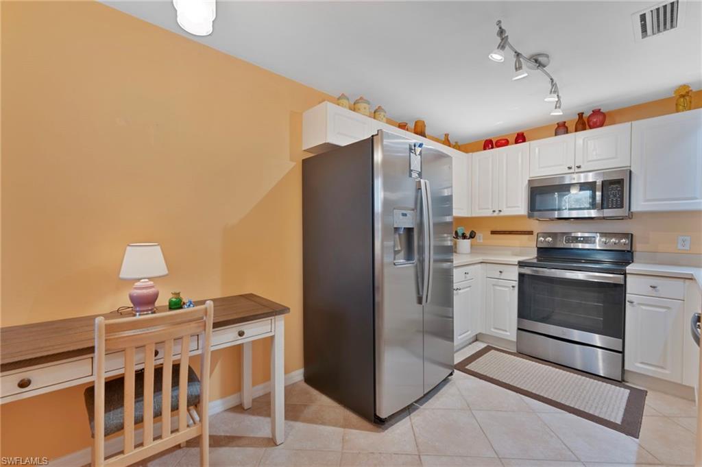 6765 Huntington Lakes Circle, Unit 102 Naples, FL 34119 - Photo 7 of 22 Ample Kitchen with Stainless Appliances, Pantry, Flexible Breakfast or Office Nook