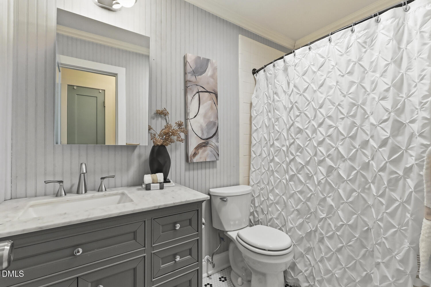 3704 Swann Street Raleigh, NC 27612 - Photo 18 of 21 a bathroom with a granite countertop toilet a sink and a mirror