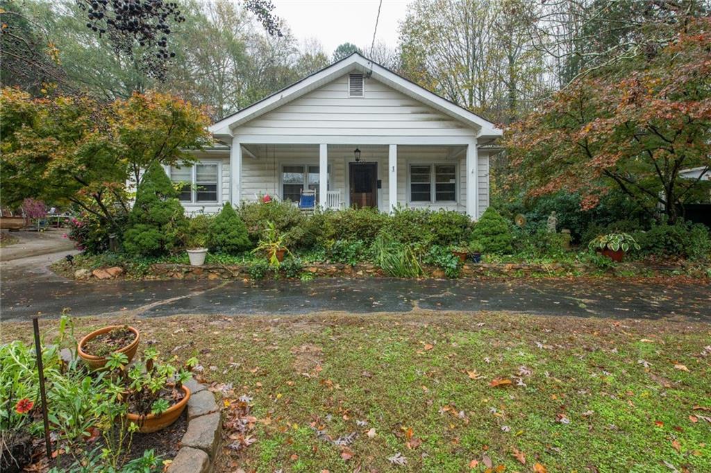 781 Sheppard Road Stone Mountain, GA 30083 - Photo 1 of 1 a front view of a house with a yard and potted plants