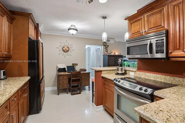 a kitchen with stainless steel appliances granite countertop a stove top oven a sink dishwasher a dining table and chairs with wooden floor