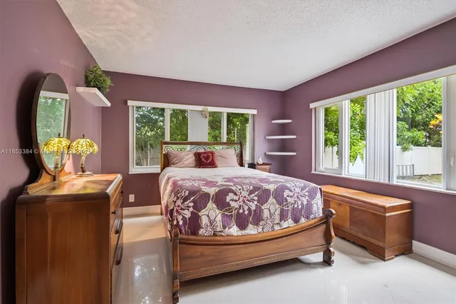 a bedroom with a bed and a mirror