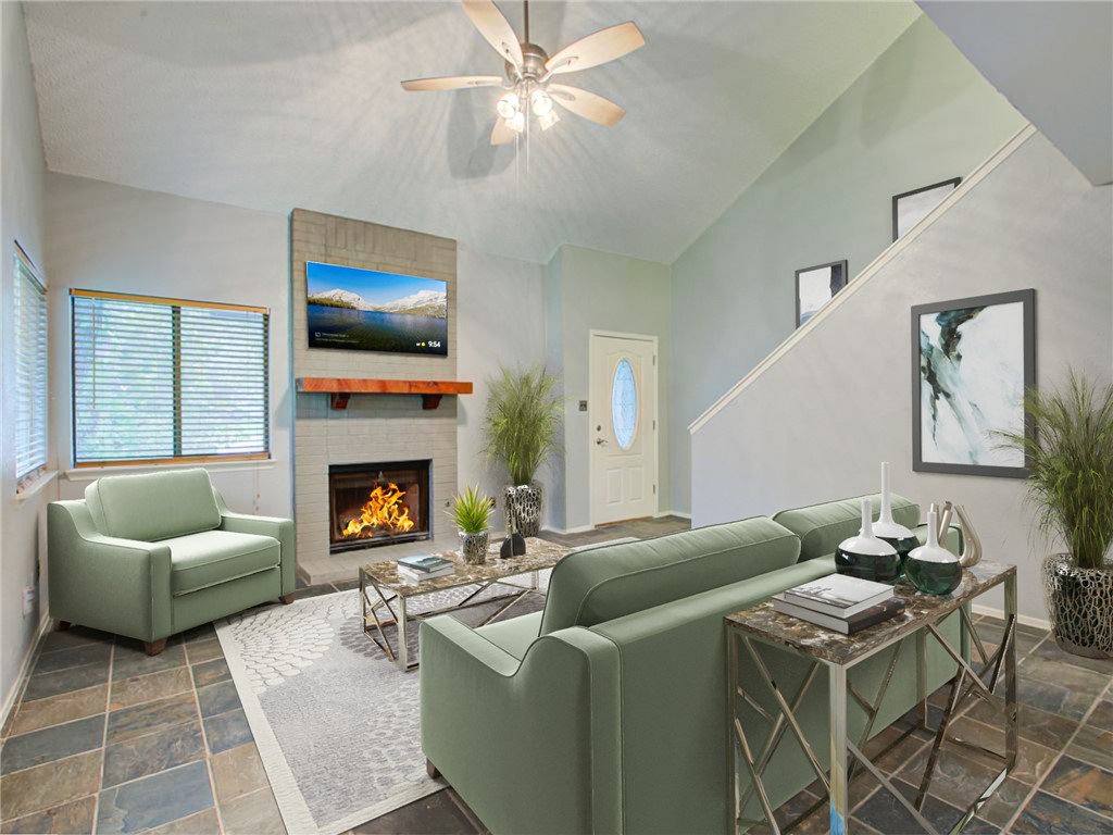 a living room with furniture and a fireplace