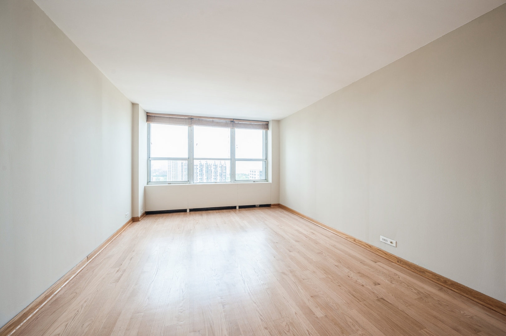 655 West Irving Park Road, Unit 2008 Chicago, IL 60613 - Photo 11 of 19 an empty room with wooden floor and windows