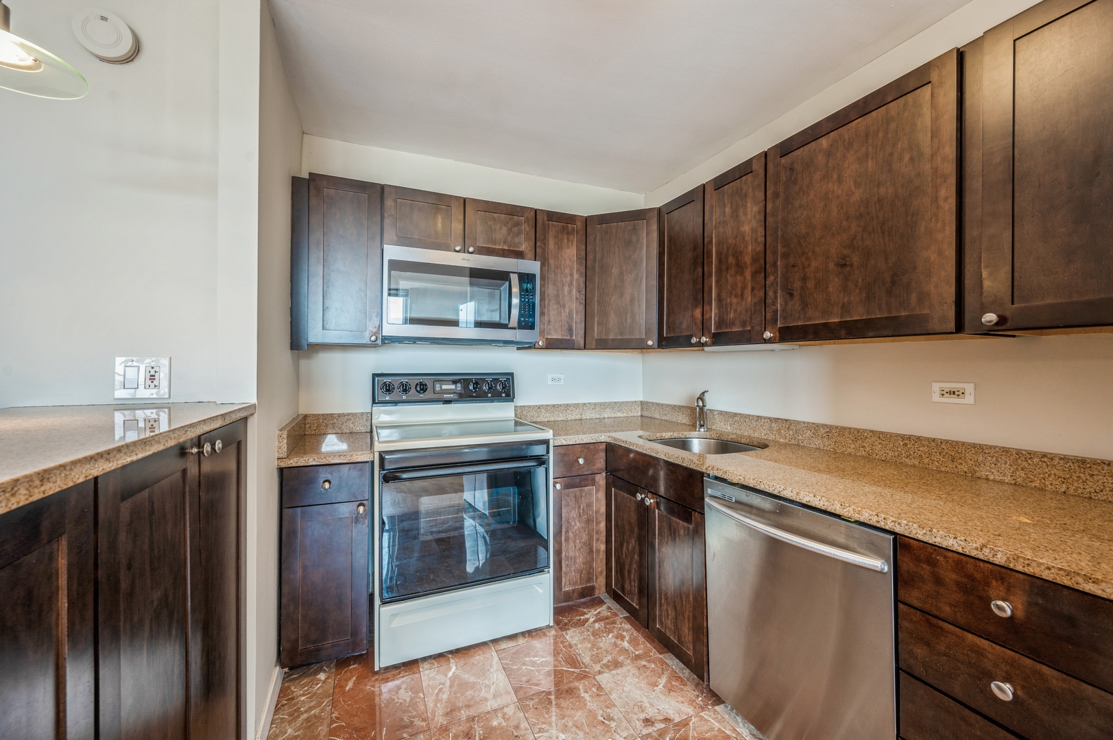 655 West Irving Park Road, Unit 2008 Chicago, IL 60613 - Photo 2 of 19 a kitchen with stainless steel appliances granite countertop a sink stove and refrigerator