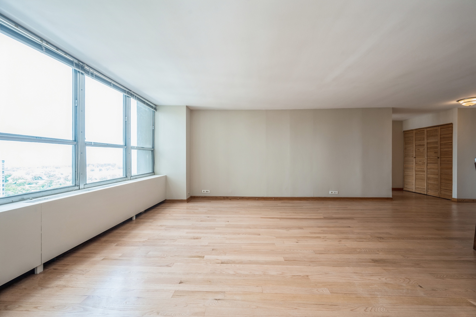 655 West Irving Park Road, Unit 2008 Chicago, IL 60613 - Photo 8 of 19 an empty room with wooden floor and windows