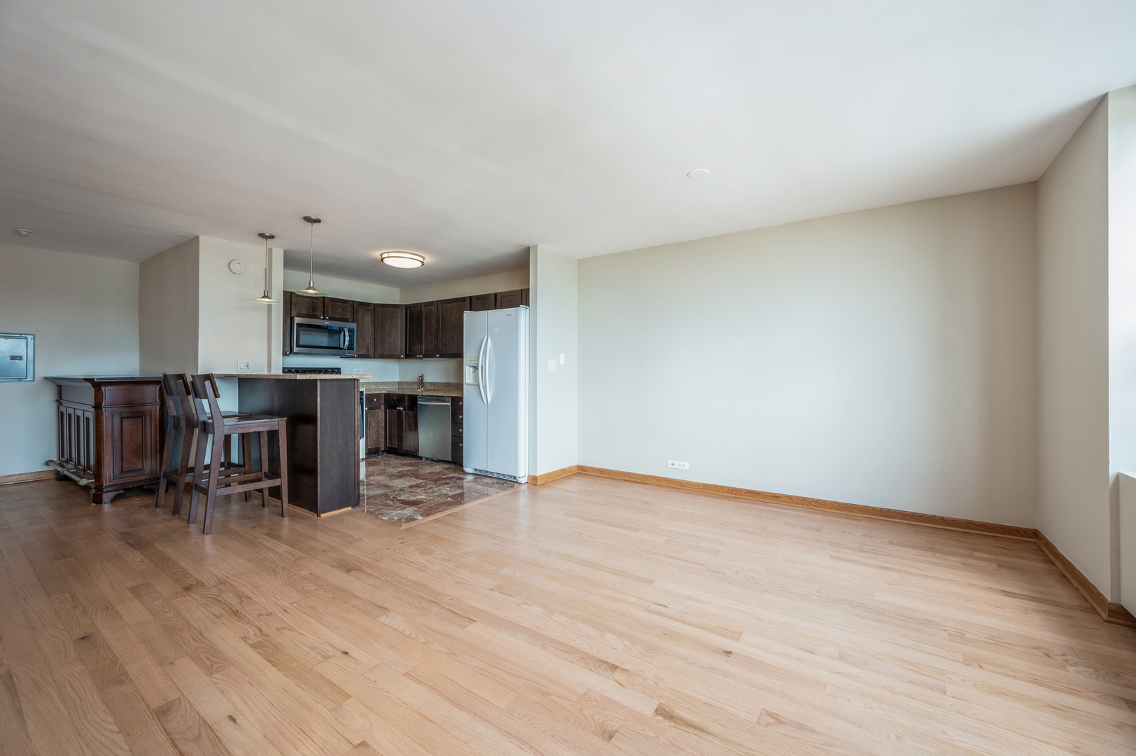 655 West Irving Park Road, Unit 2008 Chicago, IL 60613 - Photo 9 of 19 a view of kitchen with furniture and wooden floor