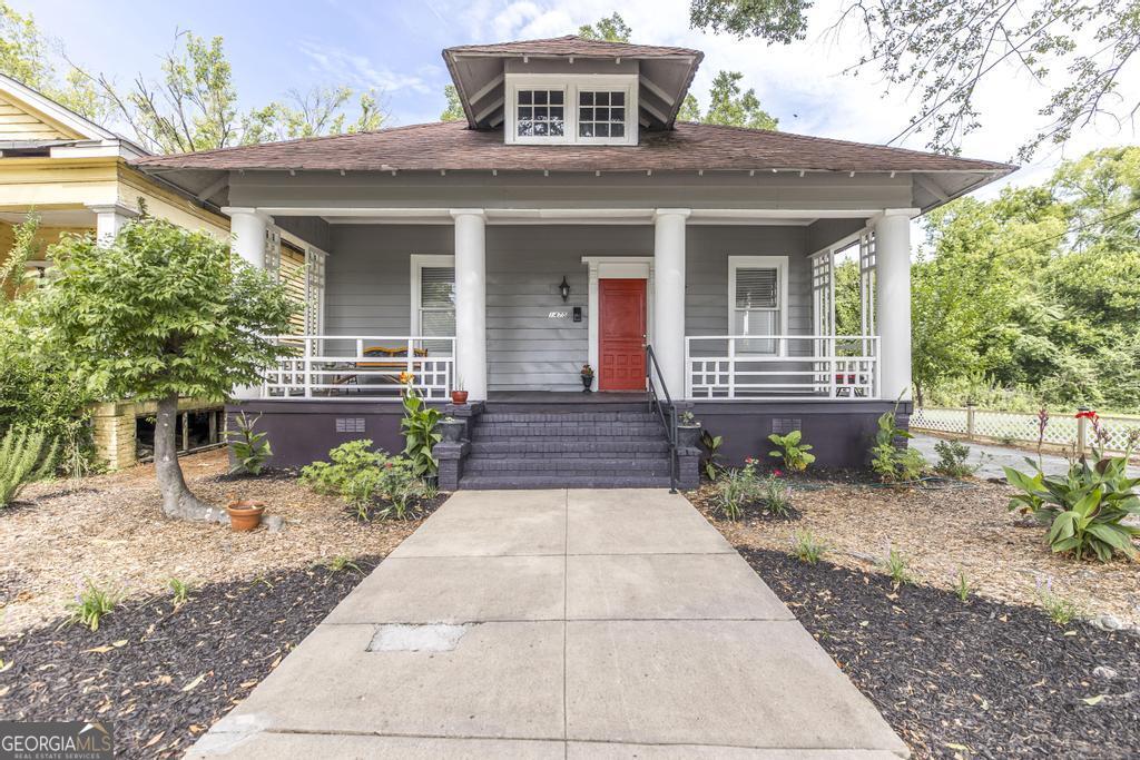 a front view of a house with a garden