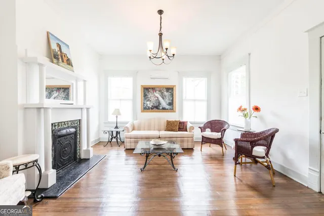 a living room with furniture fireplace and window