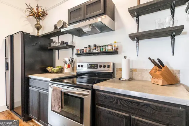 a kitchen with stainless steel appliances granite countertop a stove and a refrigerator