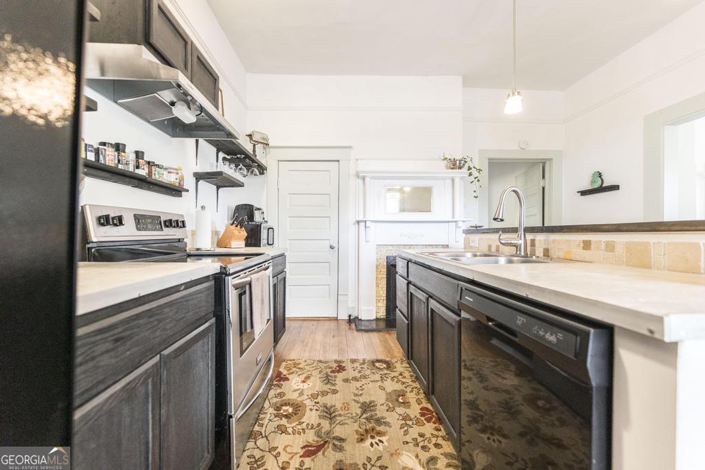 1475 3rd Street Macon, GA 31201 - Photo 19 of 37 a kitchen with stainless steel appliances granite countertop a sink and a stove