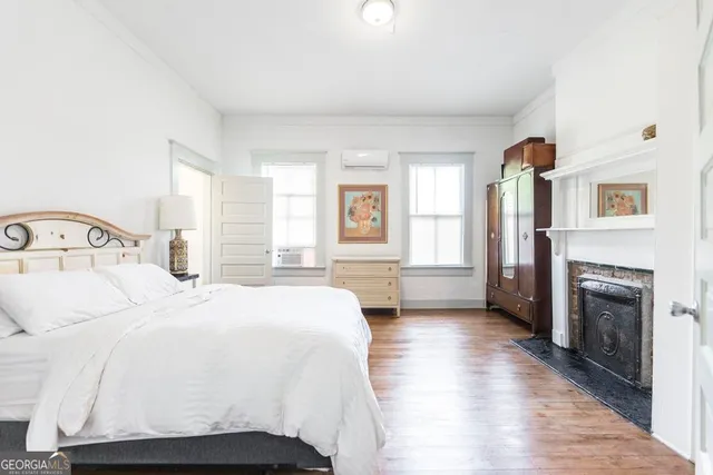 a bedroom with a bed and a fireplace