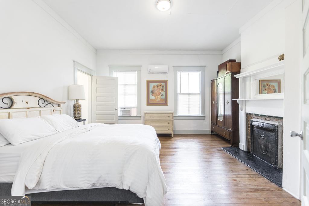 1475 3rd Street Macon, GA 31201 - Photo 21 of 37 a bedroom with a bed and a fireplace