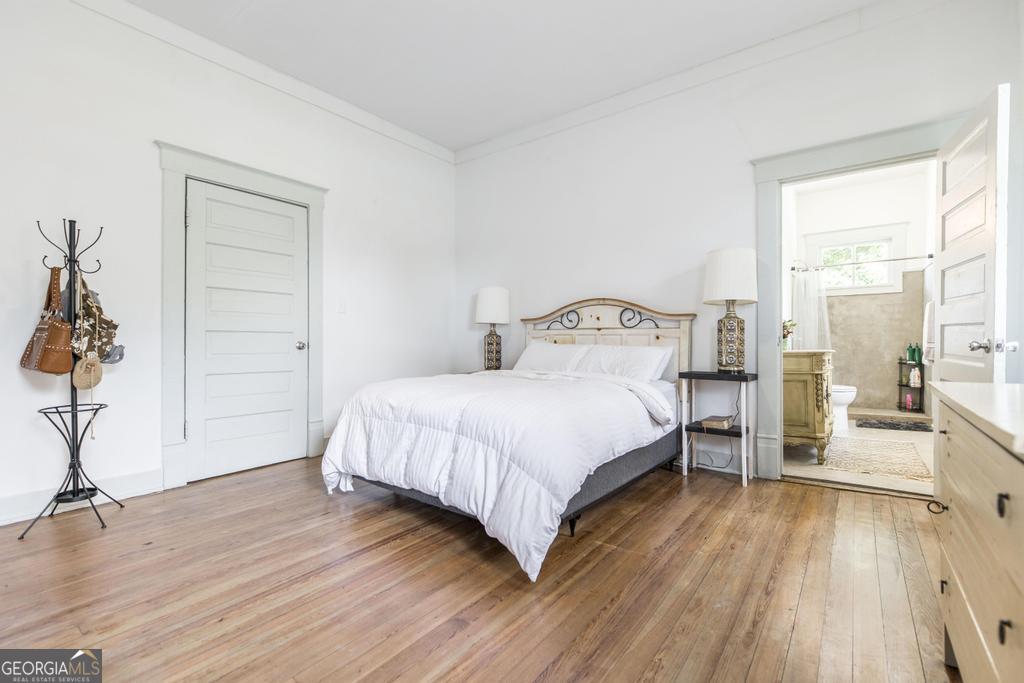 1475 3rd Street Macon, GA 31201 - Photo 23 of 37 a bedroom with a bed and wooden floor