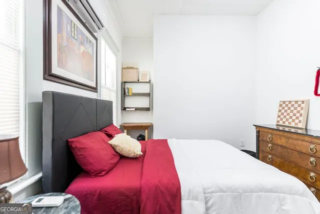 a bedroom with a large bed and a window