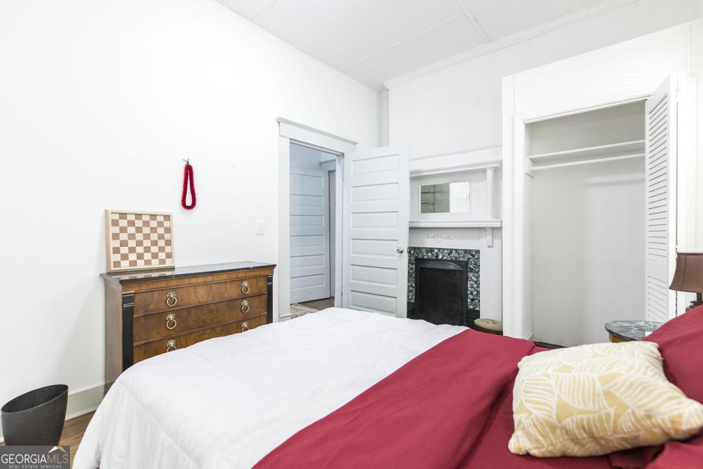 1475 3rd Street Macon, GA 31201 - Photo 27 of 37 a bedroom with a bed and a fireplace
