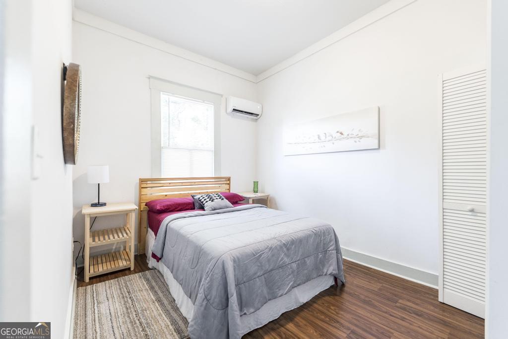 1475 3rd Street Macon, GA 31201 - Photo 29 of 37 a bedroom with a bed and wooden floor
