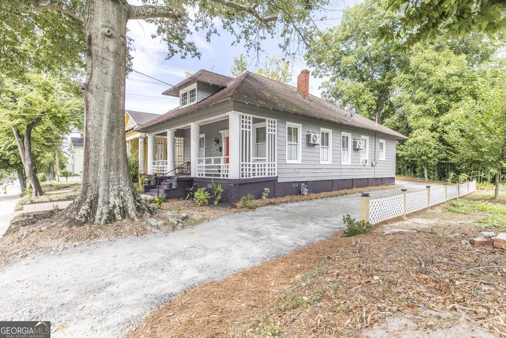 1475 3rd Street Macon, GA 31201 - Photo 4 of 37 a front view of a house with a yard and potted plants