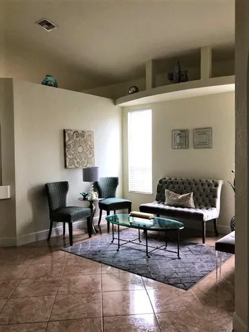 a living room with furniture and a piano