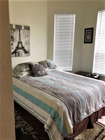 a bedroom with a bed and a window