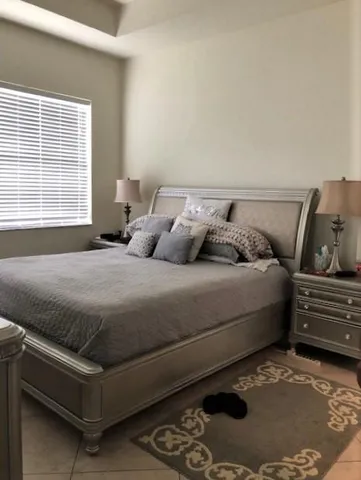 a bedroom with a bed and window