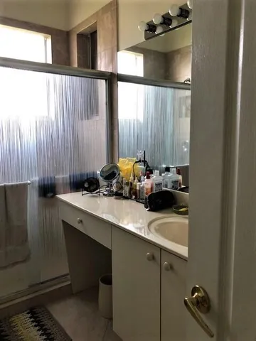 a room with a table chair and appliances