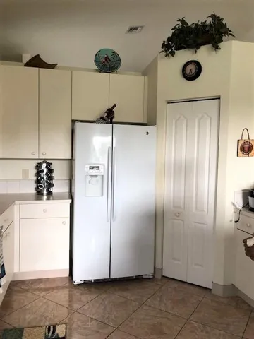 a kitchen with a refrigerator and cabinets