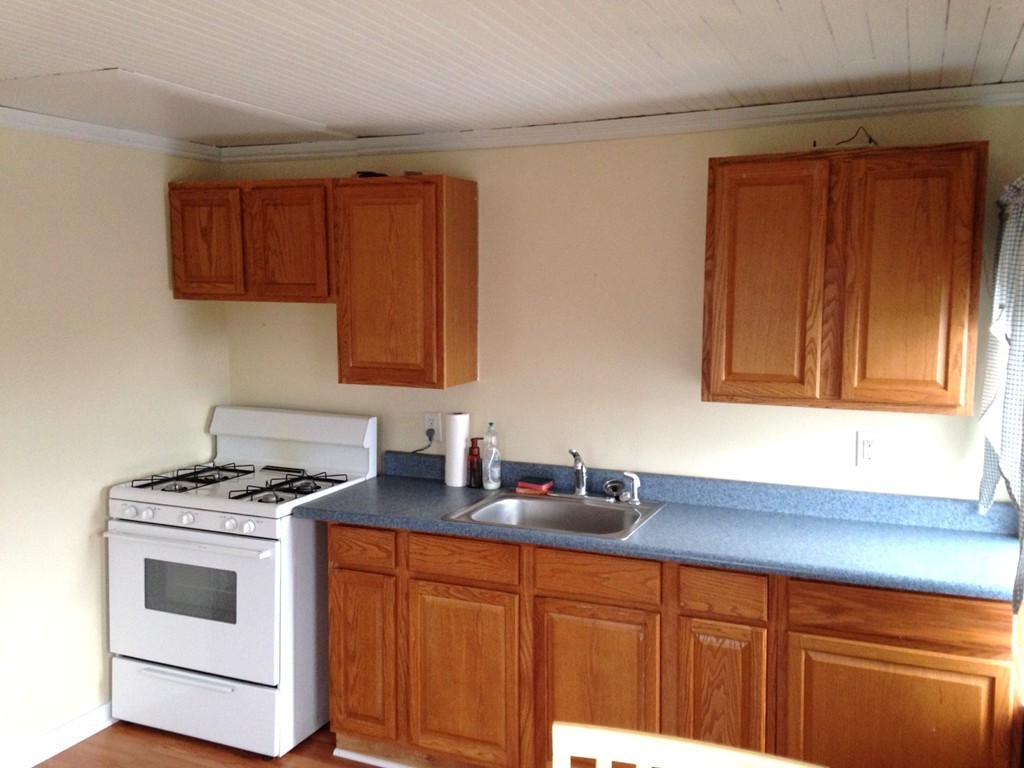 5 Malta Street Hull, MA 02045 - Photo 14 of 16 a kitchen with stainless steel appliances granite countertop a sink stove and cabinets