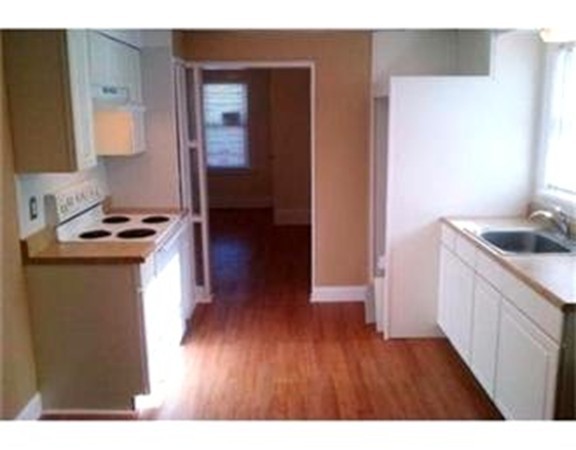 5 Malta Street Hull, MA 02045 - Photo 3 of 16 a kitchen with a wooden floor and a sink