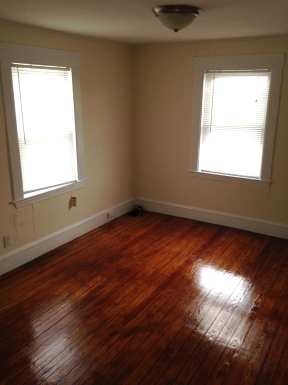 5 Malta Street Hull, MA 02045 - Photo 10 of 16 a view of an empty room with wooden floor and a window