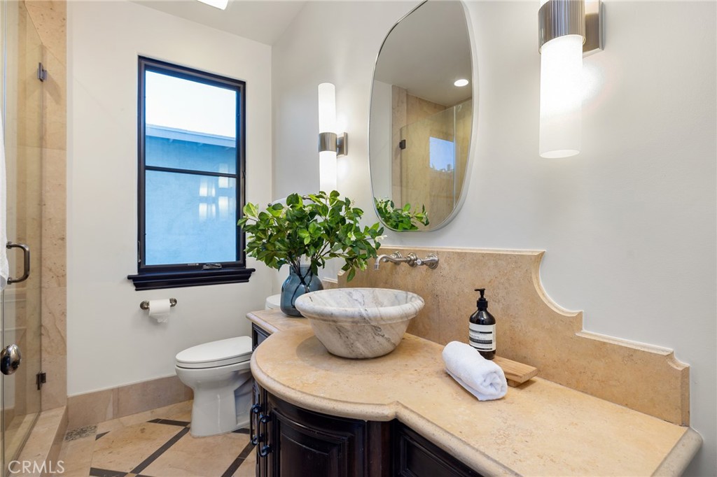 624 14th Street Manhattan Beach, CA 90266 - Photo 30 of 75 a bathroom with a toilet a sink and a mirror