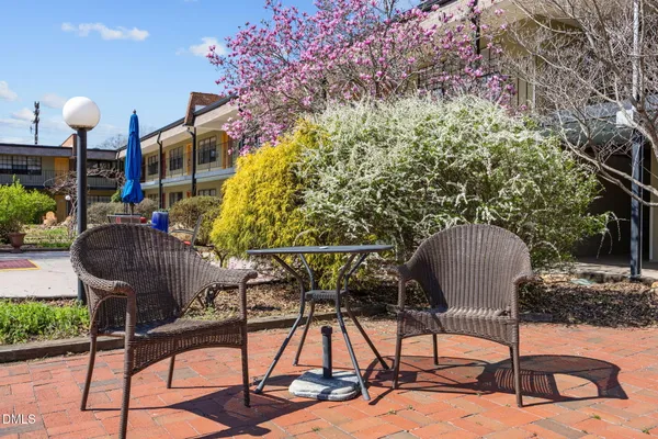a building outdoor space with patio furniture and potted plants