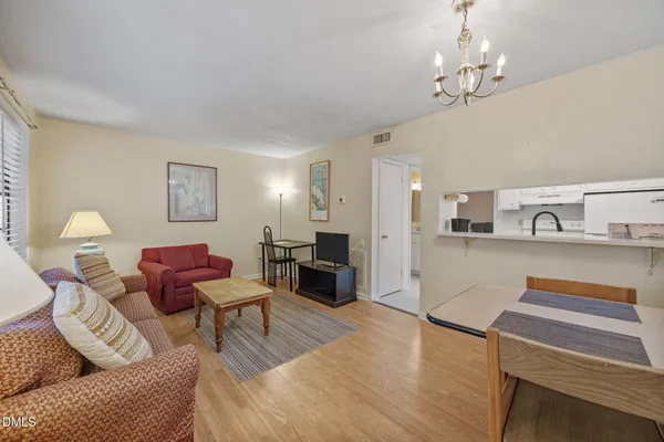 a living room with furniture and a chandelier