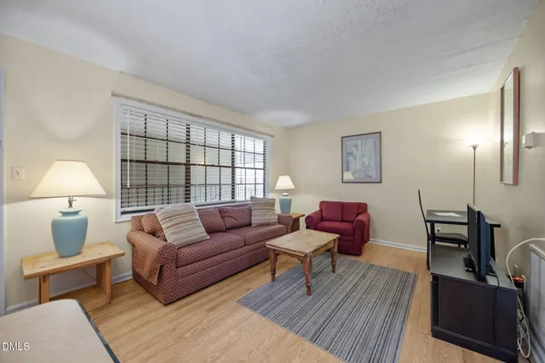 a living room with furniture and a lamp