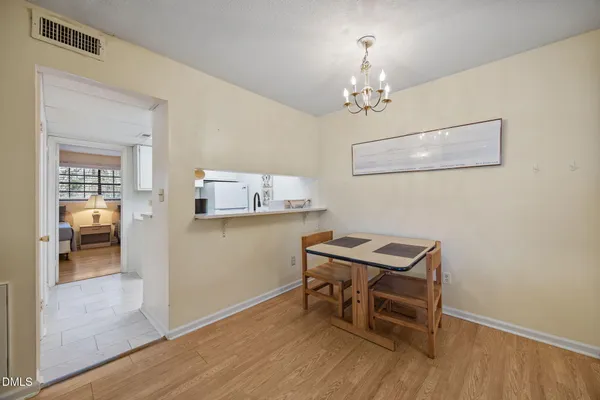 a view of a workspace with furniture and wooden floor