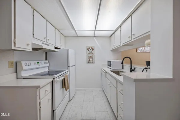 a kitchen that has a sink and a stove