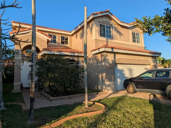 a view of a house with a small yard