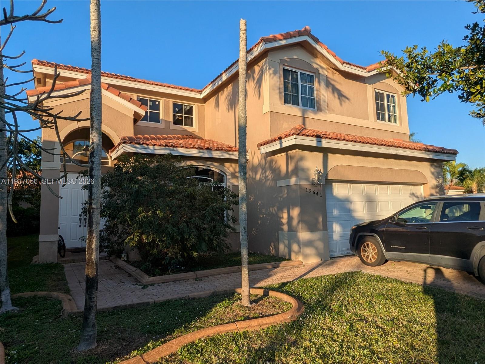 Single-family house featuring Mediterranean style architectureresidence perfect for family living, complete with an attached garage and traditional New tile roof."