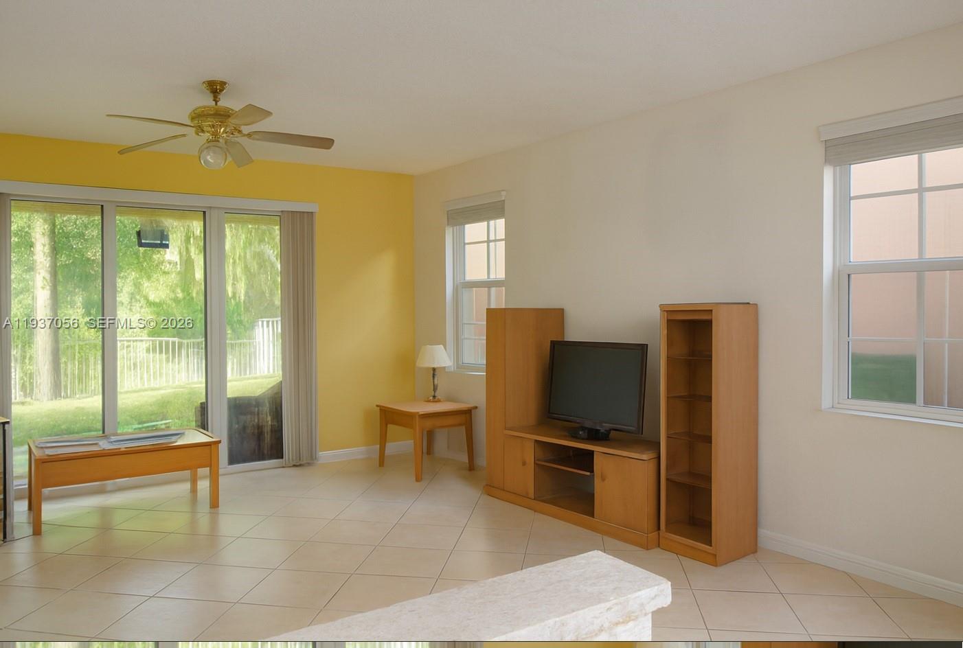 12641 Southwest 28th Street Miramar, FL 33027 - Photo 14 of 61 a living room with furniture and a flat screen tv