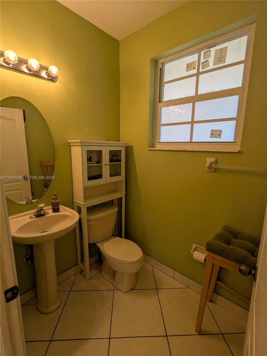 12641 Southwest 28th Street Miramar, FL 33027 - Photo 16 of 61 a bathroom with a sink toilet and mirror
