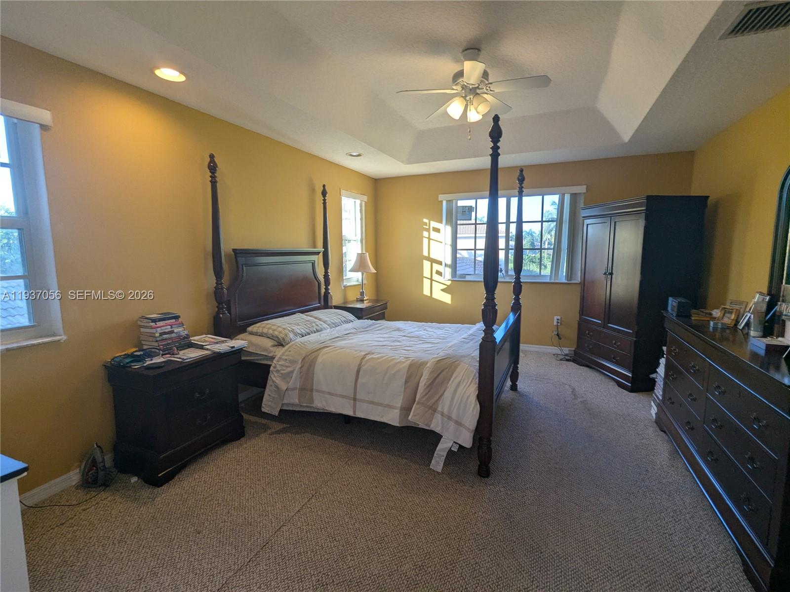 12641 Southwest 28th Street Miramar, FL 33027 - Photo 18 of 61 a spacious bedroom with a bed and a chandelier