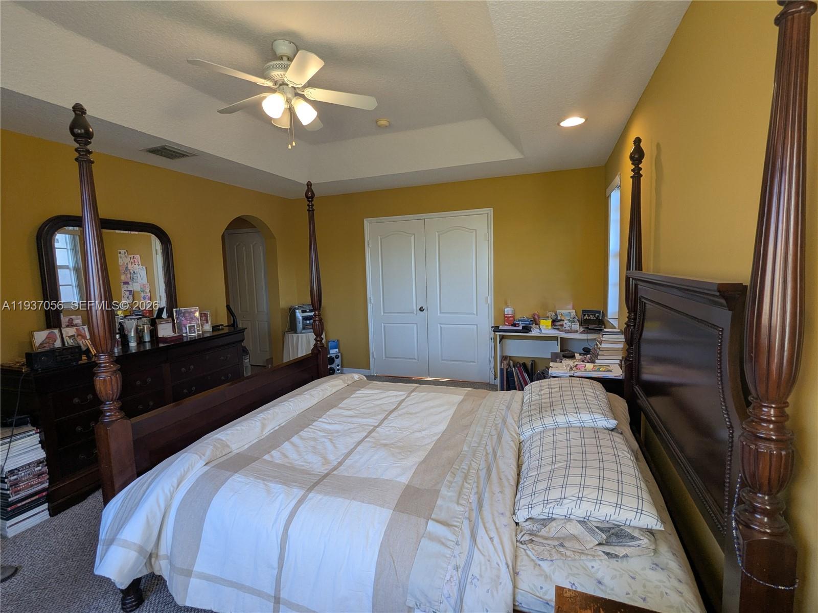 12641 Southwest 28th Street Miramar, FL 33027 - Photo 20 of 61 a bedroom with a bed a dresser and potted plants