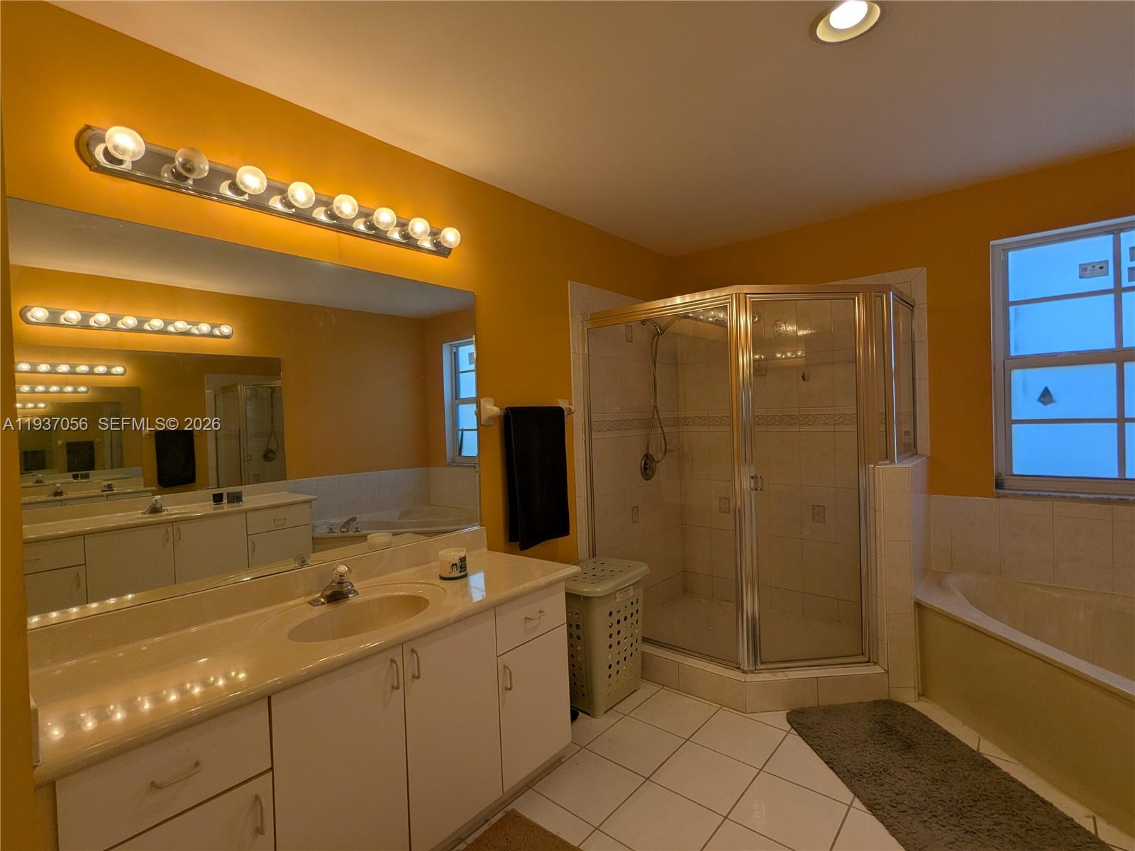 12641 Southwest 28th Street Miramar, FL 33027 - Photo 21 of 61 a bathroom with a sink a toilet and shower